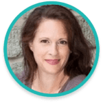 A woman with long brown hair is smiling at the camera. She is wearing a light gray top and has a light skin tone. The background appears to be a textured surface, possibly a wall. The image is framed by a turquoise circular border.